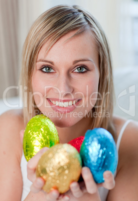 Radiant woman showing colorful easter eggs