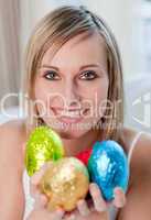 Radiant woman showing colorful easter eggs