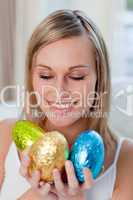 Jolly woman showing colorful easter eggs
