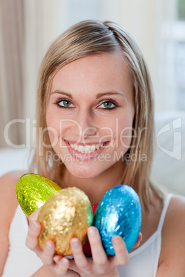 Delighted woman showing colorful easter eggs