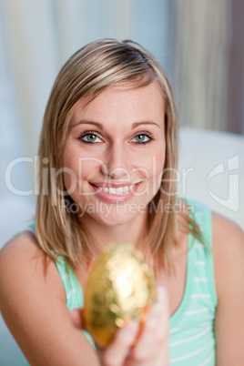 Charming woman showing an easter egg