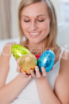 Bright woman showing colorful easter eggs