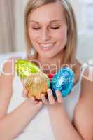 Bright woman showing colorful easter eggs
