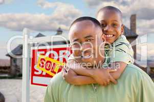 Father and Son In Front of Real Estate Sign and Home