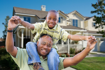 Playful Father and Son In Front of Home