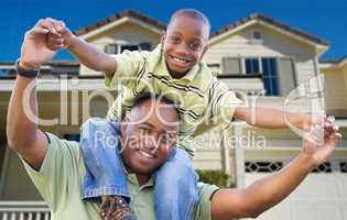 Playful Father and Son In Front of Home
