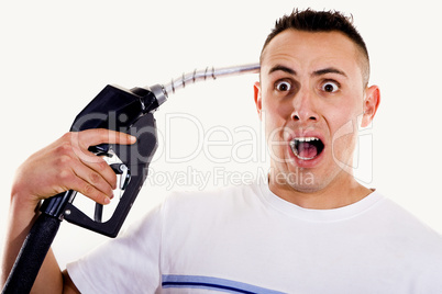 Man pointing fuel nozzle at his head