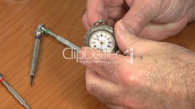 Watchmaker examine pocket watch