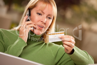 Cheerful Woman on Phone and Laptop with Credit Card