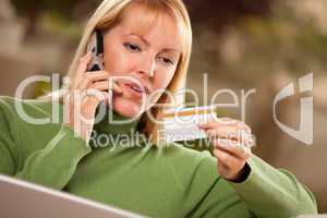 Cheerful Woman on Phone and Laptop with Credit Card