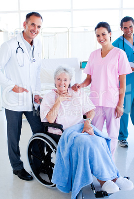 Serious medical team taking care of a senior woman