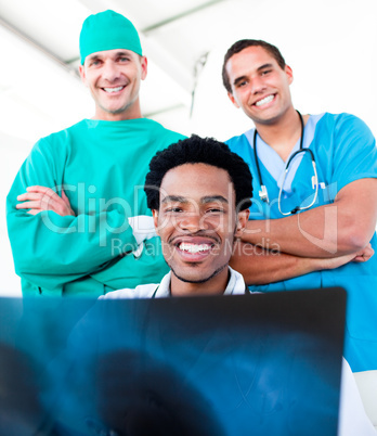 Smiling male doctors looking at X-Ray