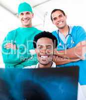 Smiling male doctors looking at X-Ray