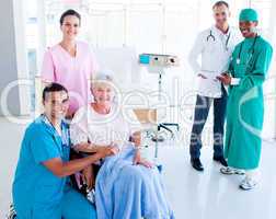 Attentive medical team taking care of a senior woman