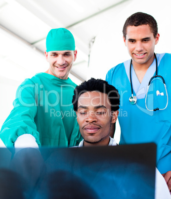 Optimistic male doctors looking at X-Ray