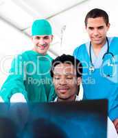 Optimistic male doctors looking at X-Ray
