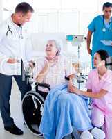 Confident medical team taking care of a senior woman