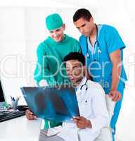 Positive male doctors looking at X-Ray