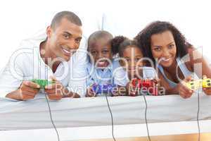 Animated family playing video game lying down on bed
