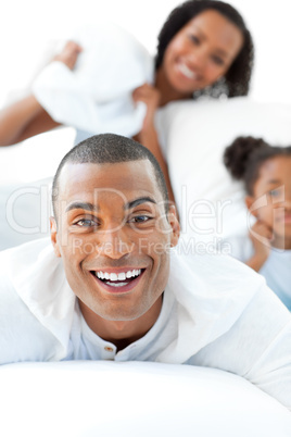 Attractive man having fun with his wife and his daughter