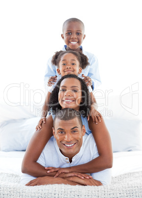 Animated family having fun lying down on bed