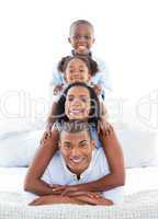 Animated family having fun lying down on bed