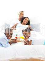 Merry family having breakfast in the bedroom