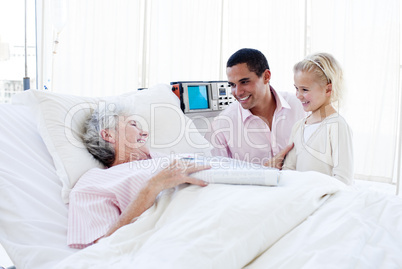 Adorable little girl with her father visiting her grandmother