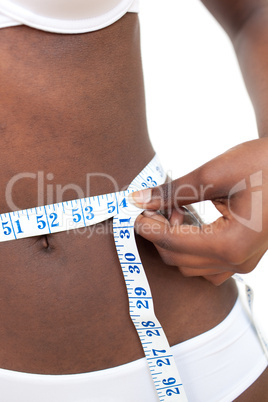 Close-up of an Afro-American woman with a tape measure