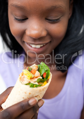 Afro-american young woman eating a wrap