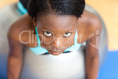 Beautiful woman working out with a pilates ball