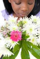 Close-up of a woman smelling flowers