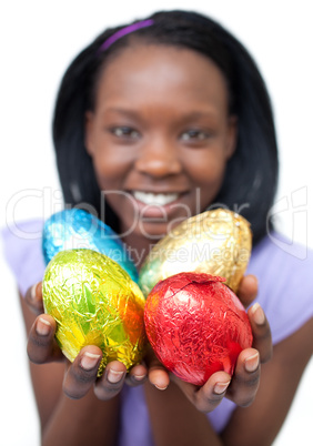 Happy ethnic woman showing Easter eggs