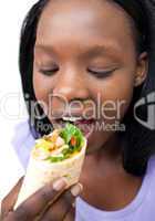 Afro-american woman eating a wrap