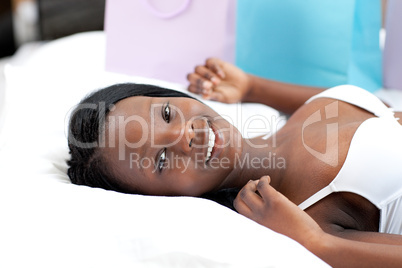 Charming woman lying after shopping