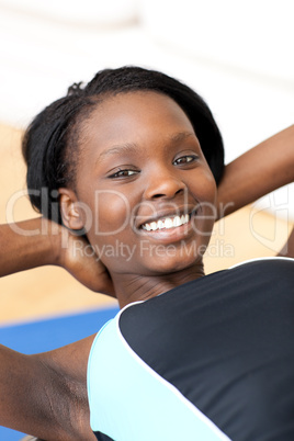 Smiling woman in gym clothes excercising
