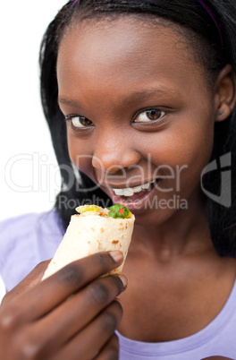 Smiling young woman eating a wrap