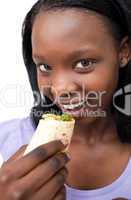 Smiling young woman eating a wrap