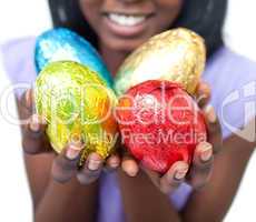 Close-up of a woman showing colorful Easter eggs