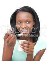 Happy young woman eating a yogurt