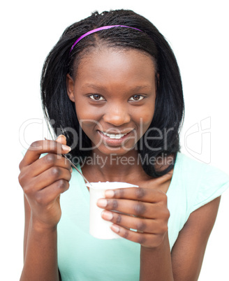 Smiling Afro-american woman eating a yogurt