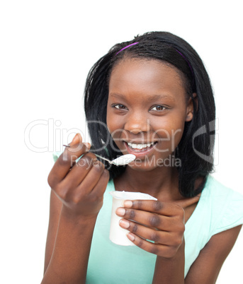 Cheerful young woman eating a yogurt