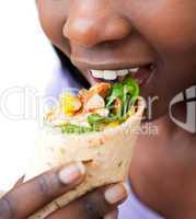 Close-up of a woman eating a wrap