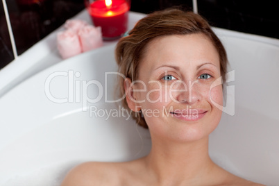 Cheerful woman relaxing in a bath