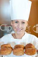 Smiling female chef baking scones