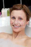 Cheerful woman having a bath in a spa