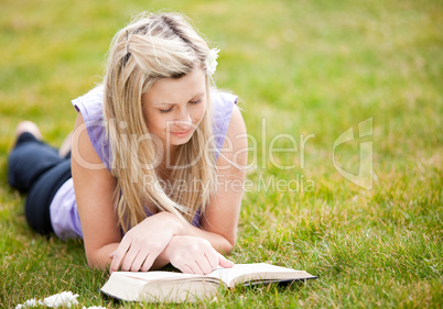 Beautiful woman reading a book in a park
