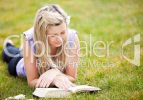 Beautiful woman reading a book in a park