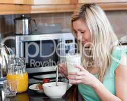 Charming woman having an healthy breakfast in a kitchen