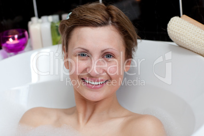 Jolly young woman having a bath